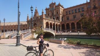riding by the plaze de espana in sevilla on a cycling tour in spain
