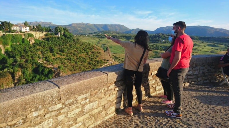 Tour guide showing views across the gorge of Ronda