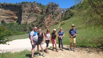 walkers in front of ronda bridge